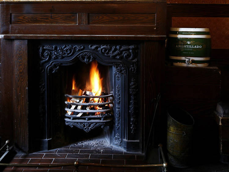 Grab a seat by the fire at The Holly Bush
